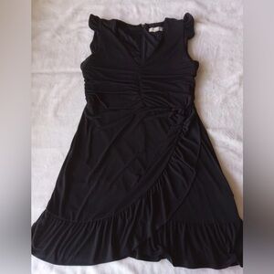 Michael Kors ruched black dress featuring flutter sleeves and a ruffled hem.